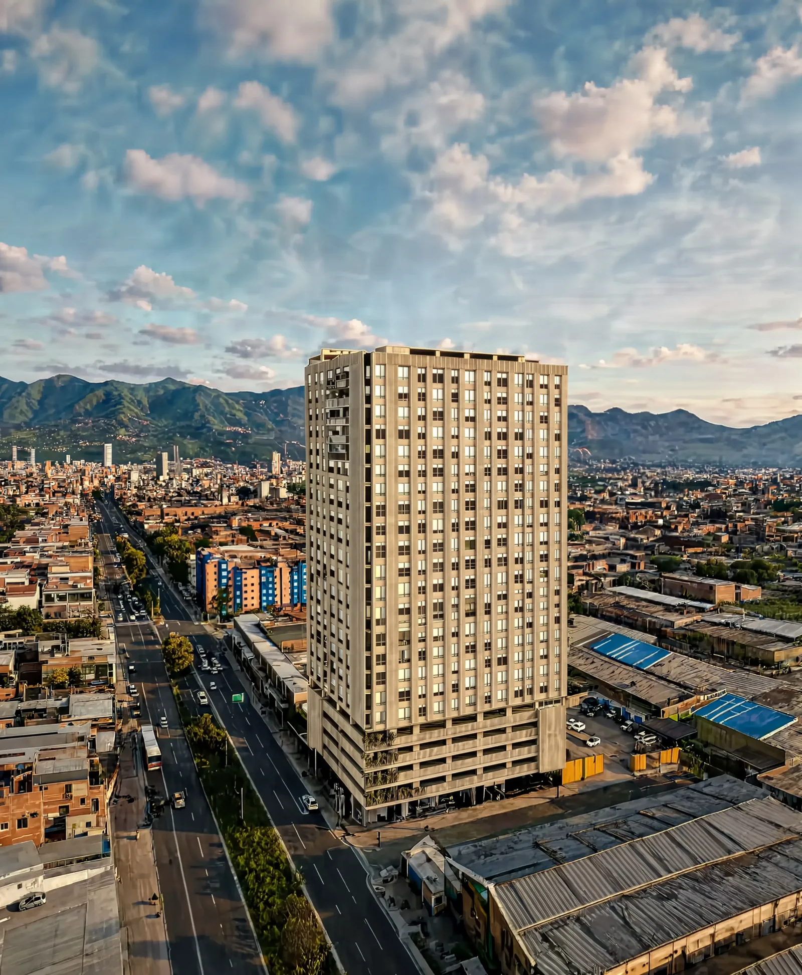 El edificio Astoria 19 visto desde el aire, con la avenida al costado, la ciudad alrededor y los cerros al fondo.